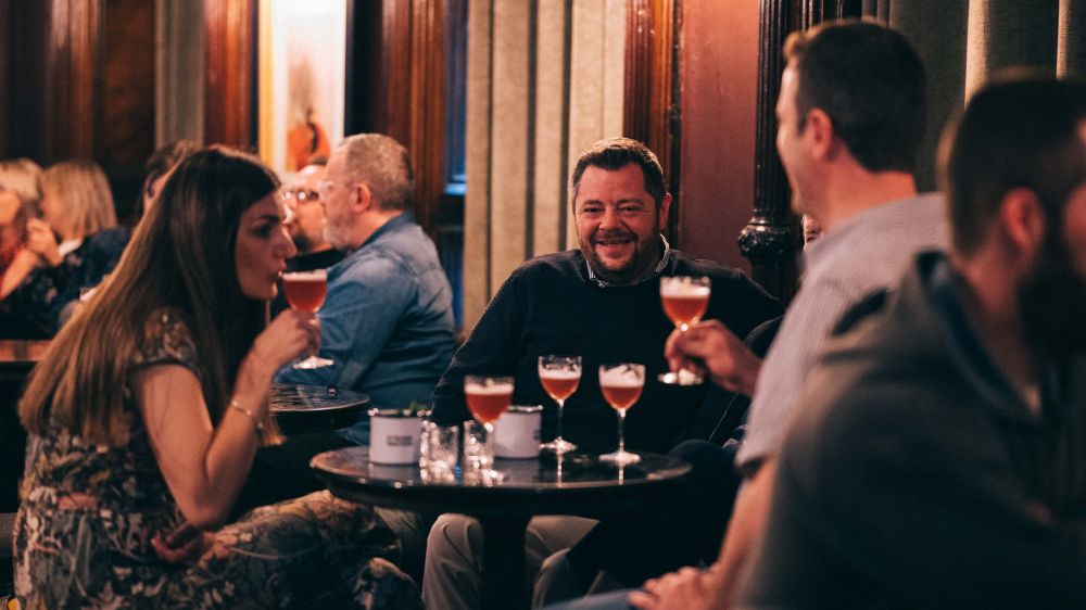 Group of two men and a woman drinking the final cocktail in the Belfast By The Glass experience