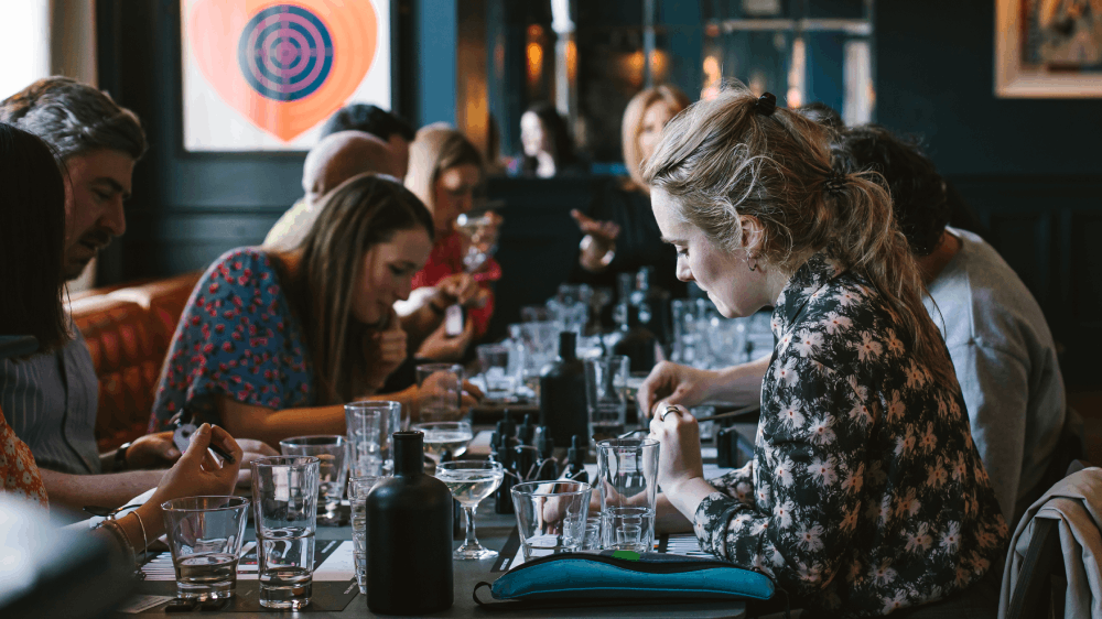 Guests of a corporate experience experimenting with taste droppers in Sensorium