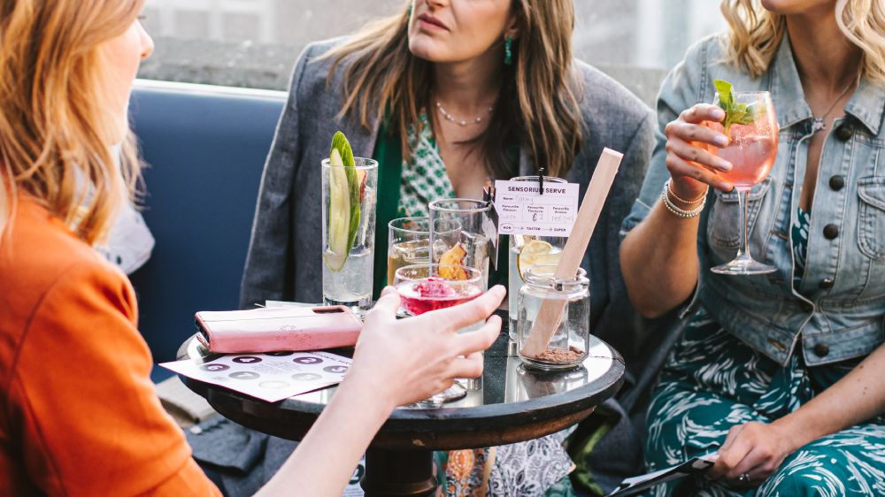 Women drinking Sensorium cocktails on The Spirit Circle rooftop garden